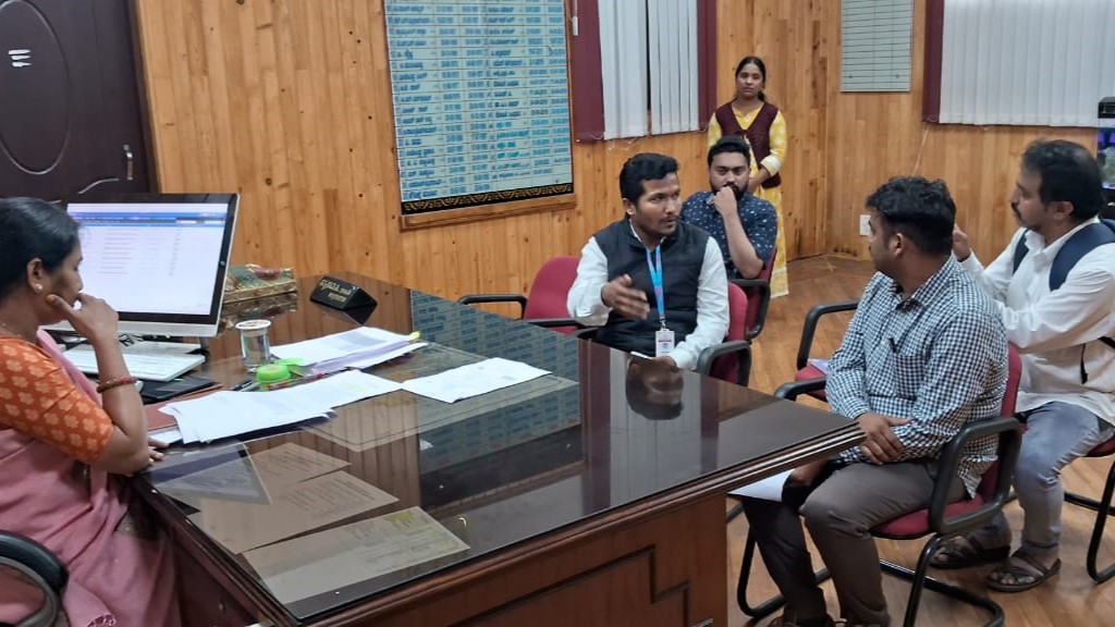 Hassan District Collector Sathyabama hands over Anusree, a computer operator in an Aadhaar centre, to the police after she was found helping Bangladeshis obtain Aadhaar cards.