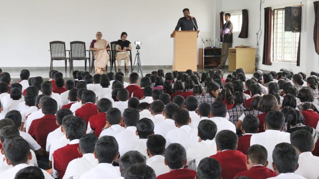 Mr. Pratap, police officer from Central Kaim Station in Hassan, addressing students of Vijaya School during an awareness camp on the perils of social media.