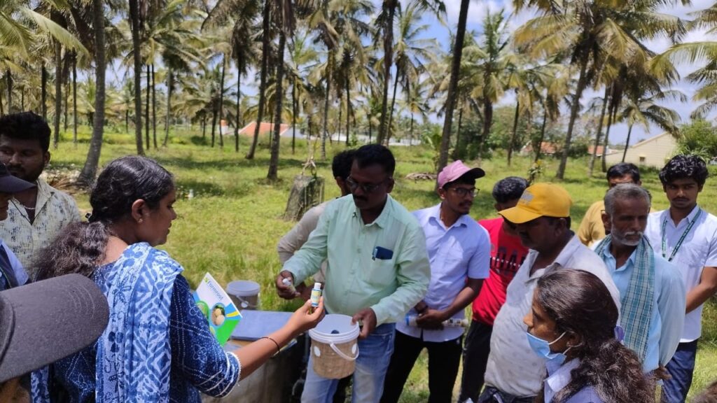 Students of Hassan Krishi Mahavidyalaya engaging with farmers at a camp on how to protect crops from insects.