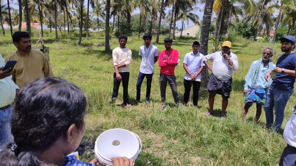 Students of Hassan Krishi Mahavidyalaya engaging with farmers at a camp on how to protect crops from insects.